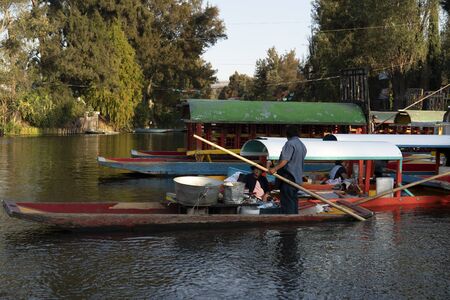 MEXICO CITY, MEXICO - JANUARY 30 2019 - Xochimilco the mexican little venice attract tourists and other city residents to ride on colorful gondola-like boats around the 170 km of canalsのeditorial素材