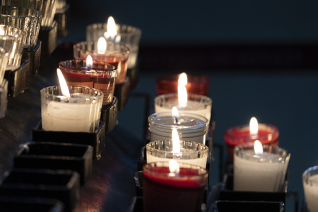 church candles whit weaving flames on black background