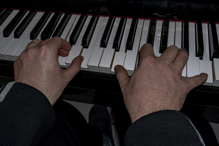 Hands playing piano while moving move effect close up