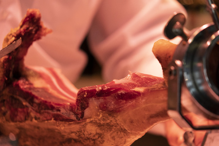 Hands while cutting spanish ham detailの写真素材