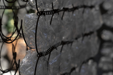 many plastic bottle on metal rusted grid