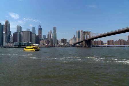 NEW YORK, USA, MAY 2 2019 - Dumbo view of Brooklyn bridge full of tourists walking on sunny day