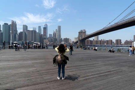 NEW YORK, USA, MAY 2 2019 - Dumbo view of Brooklyn bridge full of tourists walking on sunny dayのeditorial素材