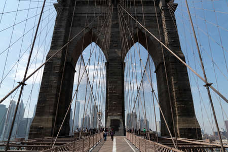 NEW YORK, USA, MAY 2 2019 - Brooklyn bridge full of tourists walking on sunny dayのeditorial素材