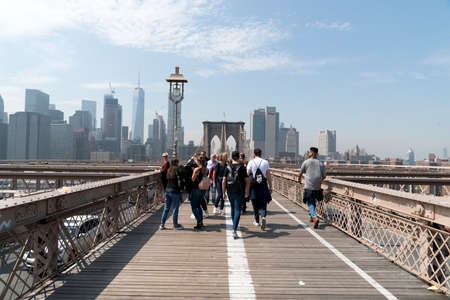 NEW YORK, USA, MAY 2 2019 - Brooklyn bridge full of tourists walking on sunny dayのeditorial素材
