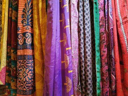 many colors indian fabric clothes at the market detailの写真素材