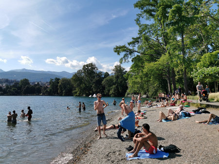 LUGANO, SWITZERLAND - JUNE 23 2019 - Lugano view cityscape from the lake full of people on sunday summer sunny dayのeditorial素材