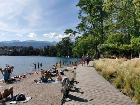 LUGANO, SWITZERLAND - JUNE 23 2019 - Lugano view cityscape from the lake full of people on sunday summer sunny dayのeditorial素材