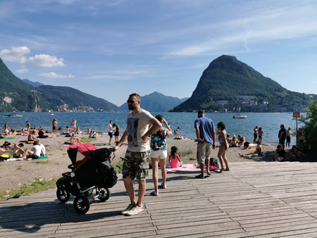 LUGANO, SWITZERLAND - JUNE 23 2019 - Lugano view cityscape from the lake full of people on sunday summer sunny dayのeditorial素材
