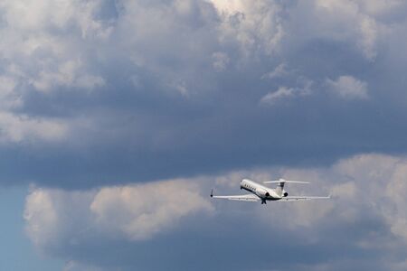 airplane after taking off on the clouds background