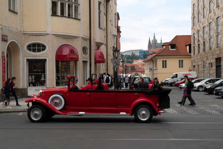 PRAGUE, CZECH REPUBLIC - JULY 15 2019 - Old style cars in Medieval town famous landmarks of the city full of tourist in summer timeのeditorial素材