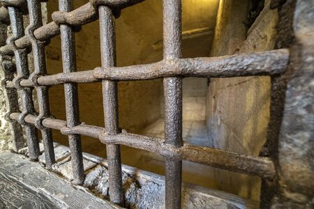 medieval prison cellar iron bars grate detailの写真素材
