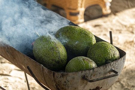 bread fruit while roasting on barbecue detail
