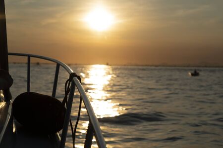 Sunset in Venice lagoon chioggia harbor from a boat landscapeの写真素材