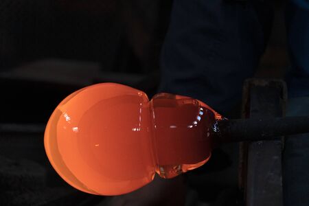 glass master while working in Murano furnace glass factory Venice Italy close up detailの写真素材