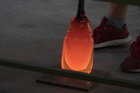 glass master while working in Murano furnace glass factory Venice Italy close up detailの写真素材