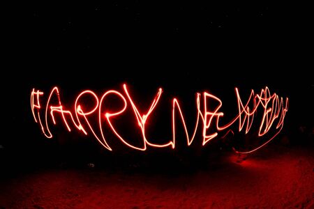 happy new year red light painting on blackの写真素材