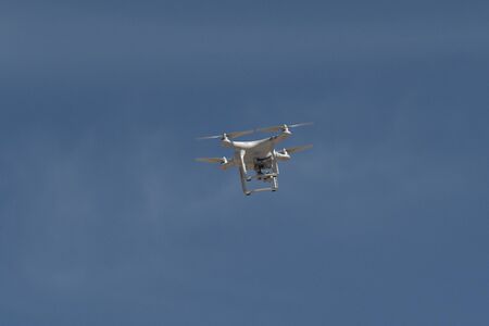 Drone isolated in blue sky backgroundの写真素材