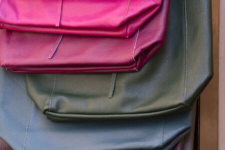 different colors leather woman bags on display at the marketの写真素材