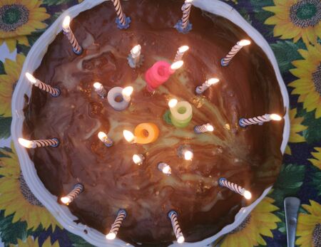 Home made birthday cake from above with candlesの写真素材