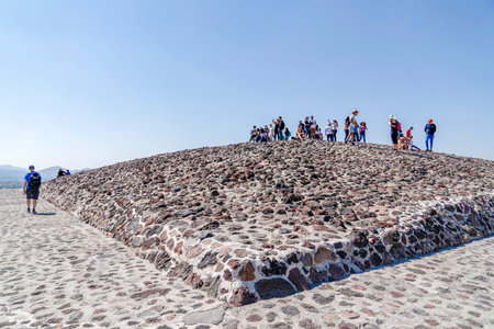 MEXICO CITY, MEXICO - JANUARY 30 2019 - Tourist climbing Teotihuacan pyramid ancient ruins one of...
