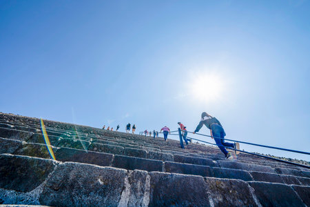 MEXICO CITY, MEXICO - JANUARY 30 2019 - Tourist climbing Teotihuacan pyramid ancient ruins one of the country most famous and visited archeological sitesのeditorial素材