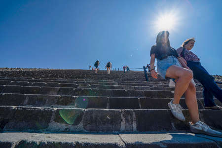 MEXICO CITY, MEXICO - JANUARY 30 2019 - Tourist climbing Teotihuacan pyramid ancient ruins one of the country most famous and visited archeological sitesのeditorial素材