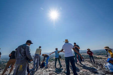 MEXICO CITY, MEXICO - JANUARY 30 2019 - Tourist making sun ceremony on top of Teotihuacan pyramid ancient ruins one of the country most famous and visited archeological sitesのeditorial素材
