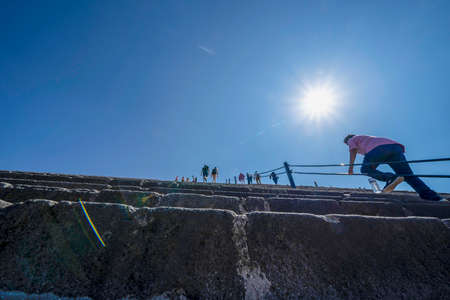 MEXICO CITY, MEXICO - JANUARY 30 2019 - Tourist climbing Teotihuacan pyramid ancient ruins one of the country most famous and visited archeological sitesのeditorial素材