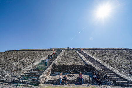MEXICO CITY, MEXICO - JANUARY 30 2019 - Tourist climbing Teotihuacan pyramid ancient ruins one of the country most famous and visited archeological sitesのeditorial素材