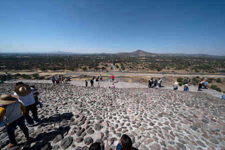 MEXICO CITY, MEXICO - JANUARY 30 2019 - Tourist climbing Teotihuacan pyramid ancient ruins one of the country most famous and visited archeological sitesのeditorial素材