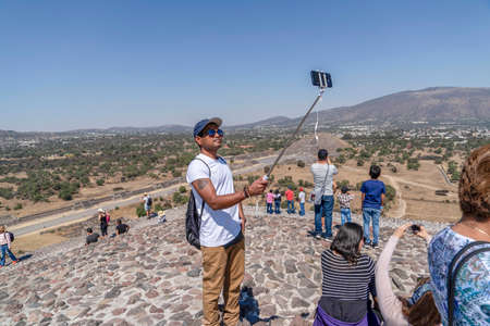 MEXICO CITY, MEXICO - JANUARY 30 2019 - Tourist climbing Teotihuacan pyramid ancient ruins one of the country most famous and visited archeological sitesのeditorial素材