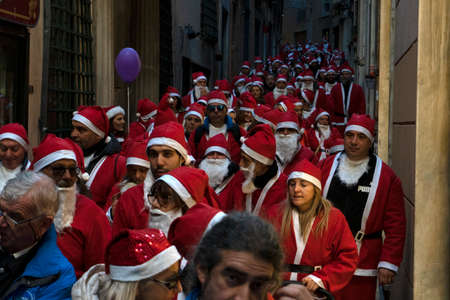 GENOA, ITALY - DECEMBER 22 2019 - Traditional Santa claus walk more than 2,000 people christmas dressed walking in town centerのeditorial素材