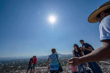 MEXICO CITY, MEXICO - JANUARY 30 2019 - Tourist making sun ceremony on top of Teotihuacan pyramid ancient ruins one of the country most famous and visited archeological sitesのeditorial素材