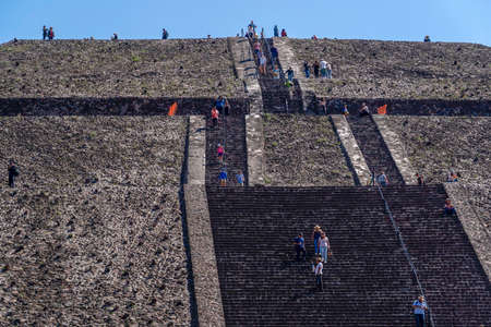 MEXICO CITY, MEXICO - JANUARY 30 2019 - Tourist climbing Teotihuacan pyramid ancient ruins one of the country most famous and visited archeological sitesのeditorial素材
