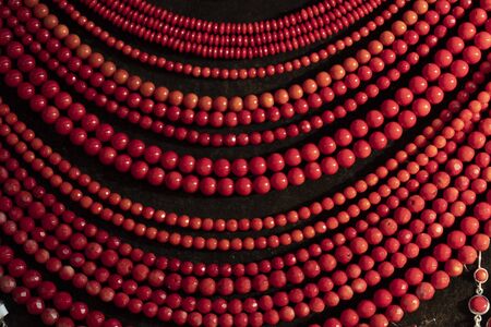 Coral necklage earrings jewelry on display stand in a shop marketの写真素材