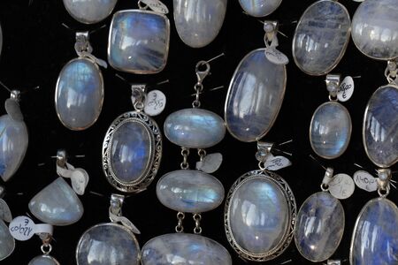 Rainbow moonstone necklage earrings jewelry on display stand in a shop market detailの写真素材