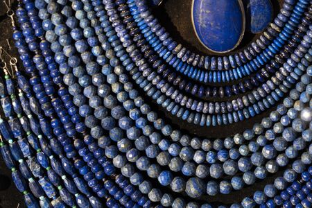 Lapislazuli necklage earrings jewelry on display stand in a shop market detail
