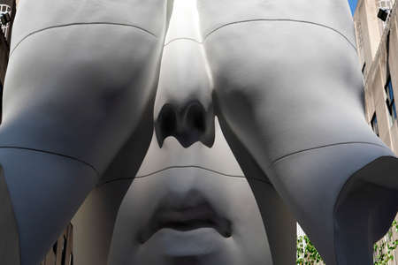 NEW YORK, USA - MAY 5 2019 -  Frieze Sculpture is a art initiative, presented at Rockefeller Center, the white man with hands on eyes is Jaume Plensa?s Behind the Wallsのeditorial素材