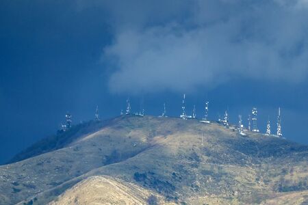 telecom cellular Communication television antennas on top of mountain before the stormの写真素材