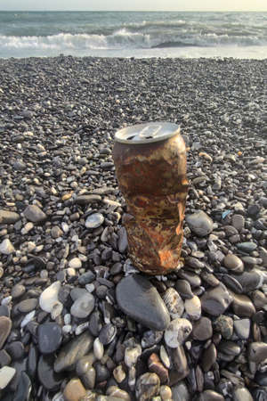 rusted can abandoned on the beach