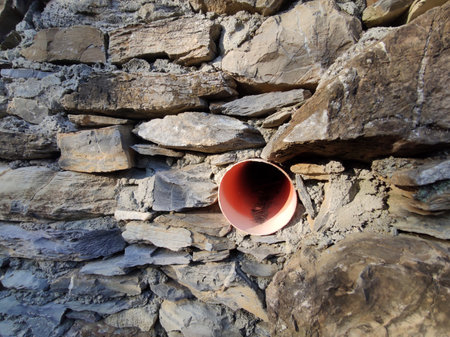 medieval wall of alley of Sant Ilario Genoa Italy with new water plastic pipe for the rainの写真素材