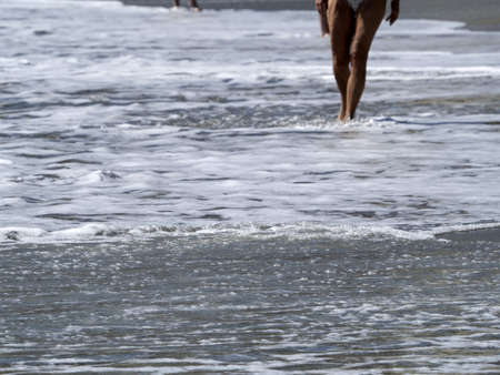 Sea wave foam on the sand beach detailの写真素材