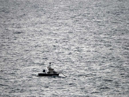 small boat in high waves sea in mediterranean