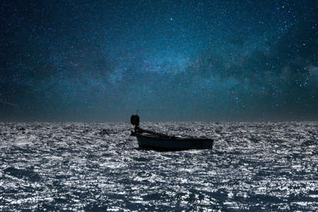 small boat in high waves sea in mediterraneanの写真素材