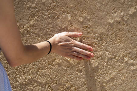 Woman hand on wet wall detailの写真素材