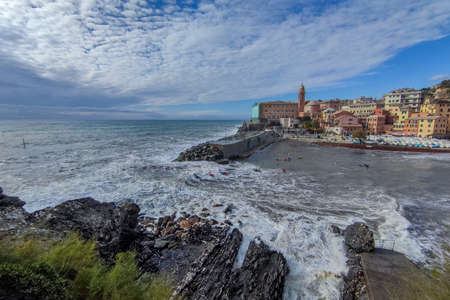 Kayaks in big waves in Genoa Nervi harbor during sea stormの写真素材