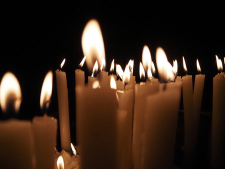 church candles weaving flames inside old medieval churchの写真素材