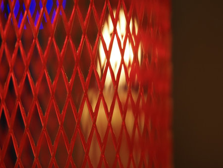 Christmas xmas candles on the table inside red platic netの写真素材