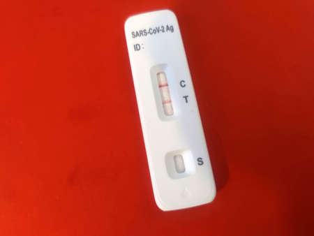 Covid rapid test kit positive result close up